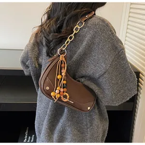 Brown leather saddle bag with colorful beaded tassel and gold chain strap back view