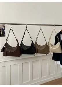 Detail of four large leather hobo bags in brown, black, coffee, and beige colors