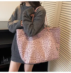 Detail of pink leopard print suede tote bag showing large capacity and shoulder strap