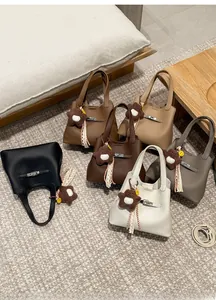 Detail view of leather bucket bags in six colors with star charms and metal hardware