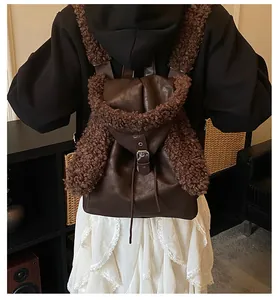 Detailed back view of a brown faux leather backpack with plush trim and drawstring closure