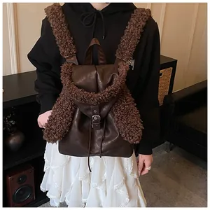 Detail of vintage brown leather backpack with fuzzy fleece trim and silver buckle closure