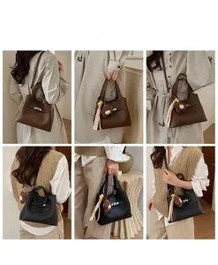 Detail showing high-quality lychee grain leather and metallic twist lock on the bucket bag