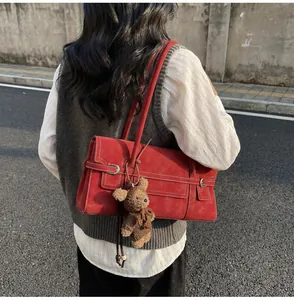 Detailed view of vintage burgundy tote bag with faux suede texture and cute teddy charm