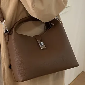 Mocha brown leather bucket bag with silver twist lock and long shoulder strap