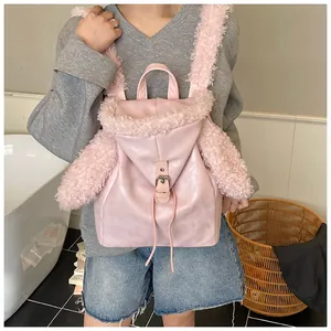 Detail of pink plush backpack featuring cute long rabbit ears and metallic buckle closure