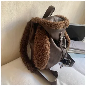 Detail of plush rabbit ears and faux fur trim on a brown leather aesthetic backpack