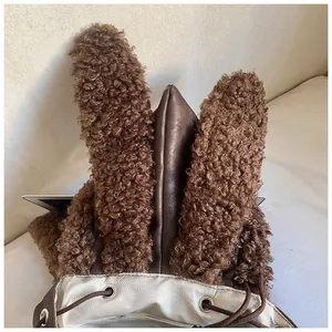 Detail of plush backpack with rabbit ears featuring drawstring and herringbone lining