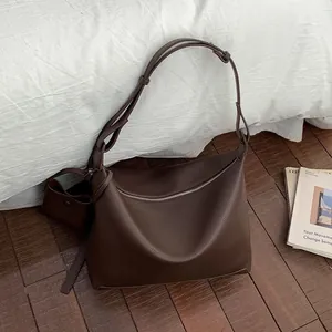 Minimalist large brown leather tote bag with lychee texture and matching mini pouch
