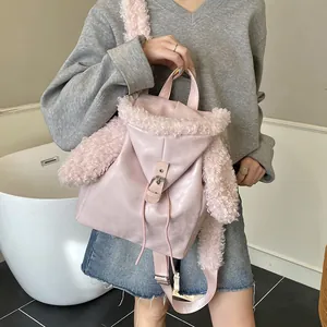 Pink plush rabbit ear backpack with metal buckle closure shown on model for daily style