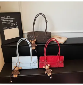 Detailed view of vintage shoulder bags with buckle detail and cute plush bear charms