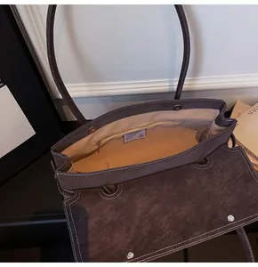 Detail shot of the large capacity shoulder bag interior with magnetic clasp and zipper pocket