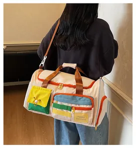 Detail of multi-pocket travel bag with Happy Weekend text shown on a model's shoulder