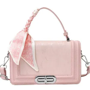 Pink minimalist crossbody square bag with textured finish and decorative heart scarf