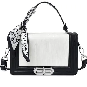 Minimalist black and white crossbody bag with silver lock and heart print scarf