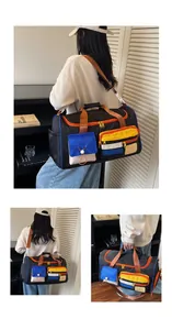 Detail view of large travel bag featuring multi-color pockets and Happy weekend label