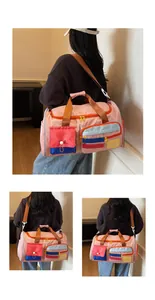Detail of multi-pocket travel bag with pink contrast colors and Happy weekend label