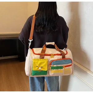 Detail of multi-pocket travel bag showing colorful zippers and durable nylon material