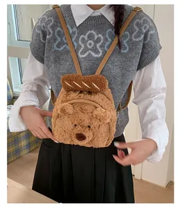 Detailed view of brown plush teddy bear backpack with baguette design and faux leather straps