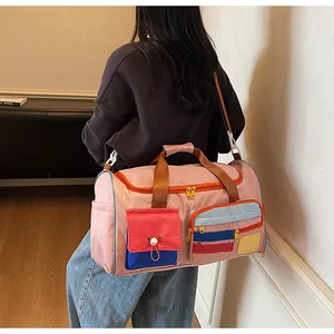 Detail view of pink patchwork travel bag with Happy Weekend patch and colorful pockets