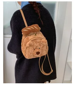 Detail of cute plush bear backpack with 3D baguette decor and adjustable leather straps