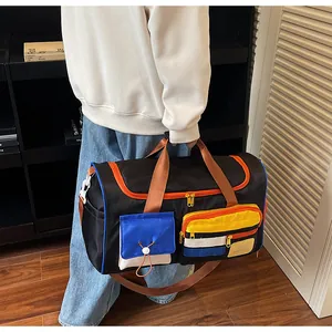 Detail of multi-pocket travel bag with orange zippers and blue pocket on home background