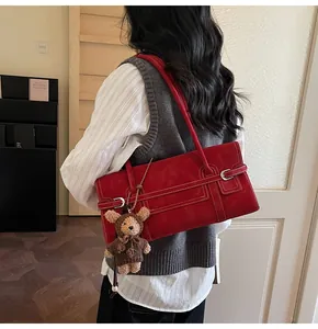 Red retro rectangular shoulder bag with white stitching and brown bear plush charm