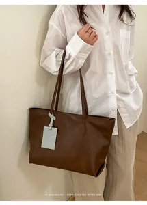 Deep brown retro leather tote bag worn by a model in a minimalist daily commute style