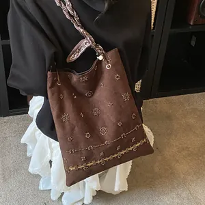 Brown suede tote bag with intricate beadwork and floral embroidery in bohemian style