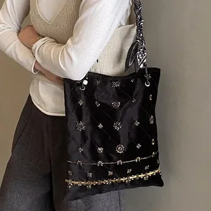Ethnic suede tote bag with gold bead embroidery and dotted silk scarf handle