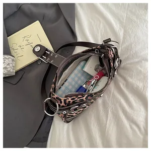 Internal capacity of leopard print tote bag holding lipstick, phone and cosmetics
