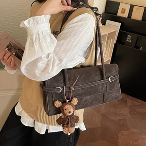 Dark brown faux suede shoulder bag with contrast stitching and a cute bear charm
