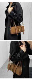 Detail of dark brown Boston bag with vintage gold padlock and detachable thin shoulder strap