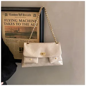 Detail showing glossy quilted leather texture and golden twist lock on chain bag