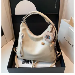 Beige tote bag in a black gift box with a plush charm and soft leather texture