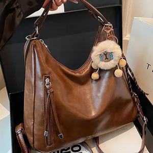 Vintage brown leather tote bag with tassel zipper and cute plush charm in gift box