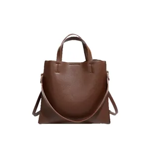 Dark brown lychee grain leather tote bag with top handles and adjustable strap