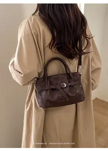Minimalist retro dark brown PU leather bucket bag with decorative strap and adjustable handle