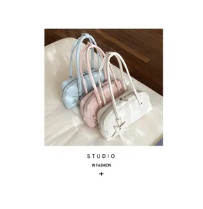 Detailed view of minimalist long shoulder bags in blue, pink, and white with star charms