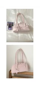 Detailed view of pink minimalist shoulder bag with star charm and zip closure