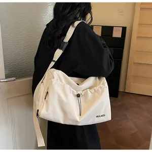 Detail der cremeweißen Canvas-Reisetasche mit Kordelzugtasche und verstellbarem Gurt