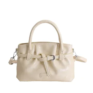Beige minimalist PU leather bucket bag with top handles and silver metal buckle detail