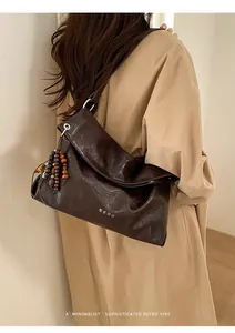 Detail of dark coffee vintage tote bag with wooden bead tassels and Korean text pattern