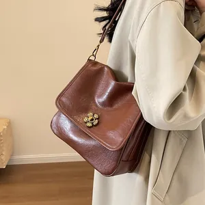 Retro dark brown leather shoulder tote bag with a floral metal twist lock for women