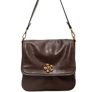 Vintage brown oil wax leather shoulder bag with decorative bronze flower buckle and strap