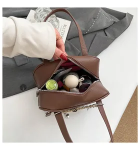 Top view of brown lychee grain leather handbag showing spacious red interior storage