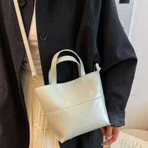 Chic cream leather tote bag for women with dual handles and gold hardware in street style