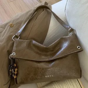 Retro dark brown oily leather tote bag with silver ring detail and wooden bead tassel