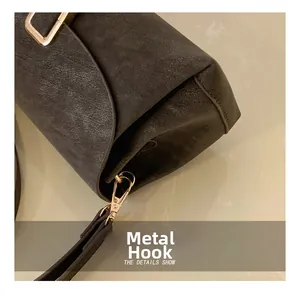 Detailed macro view of vintage textured leather with golden hardware hook and D-ring