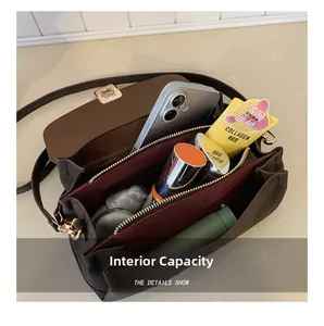 Detail view of the spacious internal compartments and storage capacity of the brown handbag